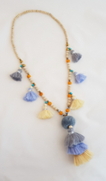 Long necklace in wood beads in rosaries design with Multi Tassels and Pompoms